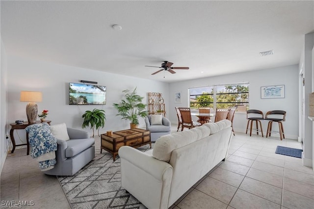 living room featuring light tile patterned floors and ceiling fan