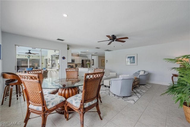 tiled dining space featuring ceiling fan