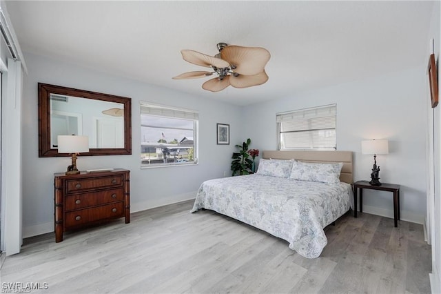 bedroom with ceiling fan and light hardwood / wood-style flooring