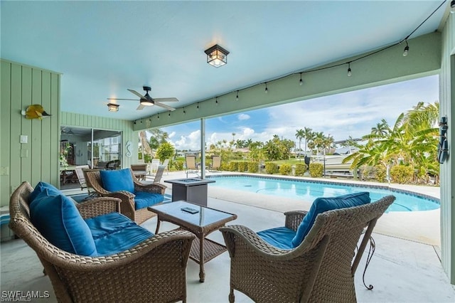 view of swimming pool with ceiling fan and a patio area