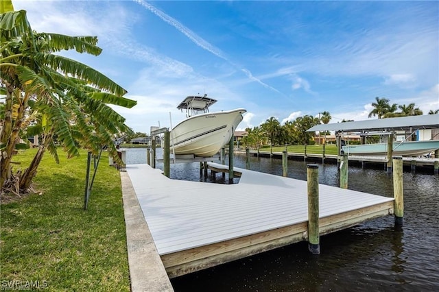 dock area featuring a water view and a lawn