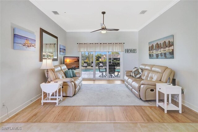 living room with hardwood / wood-style flooring, crown molding, and ceiling fan