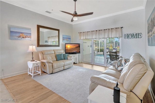 living room featuring ornamental molding, light hardwood / wood-style floors, and ceiling fan