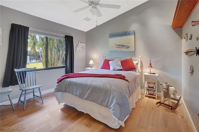 bedroom with vaulted ceiling, ceiling fan, and light hardwood / wood-style flooring