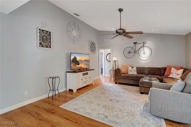 living room featuring high vaulted ceiling, ceiling fan, and light wood-type flooring