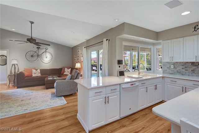 kitchen featuring white cabinetry, sink, white dishwasher, and light hardwood / wood-style flooring