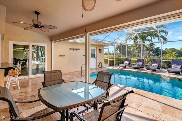 view of swimming pool featuring a lanai, ceiling fan, and a patio area