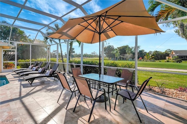 view of patio featuring outdoor dining area and a lanai