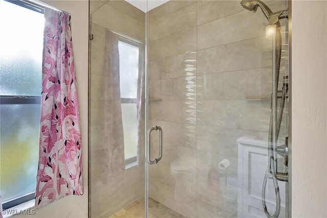 bathroom featuring a shower with shower door