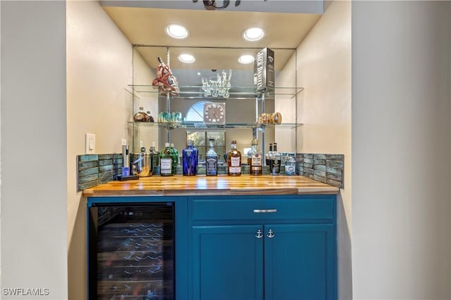 bar featuring blue cabinets, butcher block counters, and wine cooler