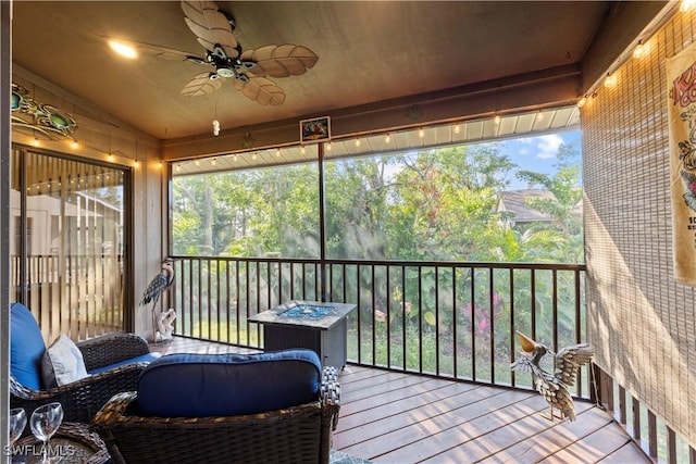 sunroom / solarium with lofted ceiling and ceiling fan