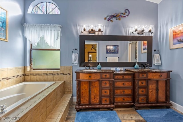 bathroom featuring vanity and a relaxing tiled tub