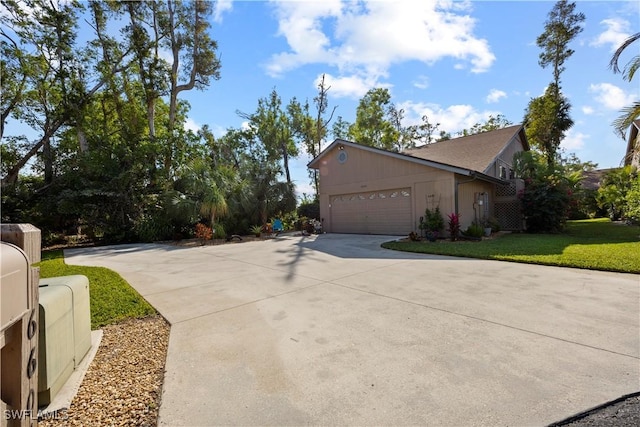 view of side of home featuring a yard and a garage