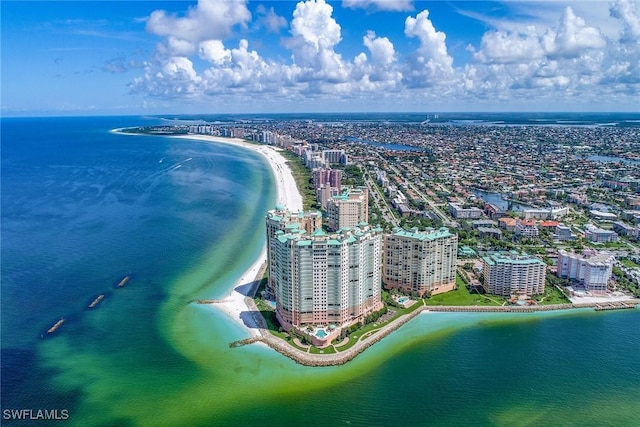 bird's eye view with a water view and a beach view