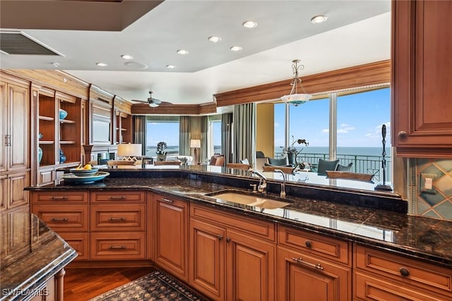 kitchen with a water view, sink, pendant lighting, and plenty of natural light