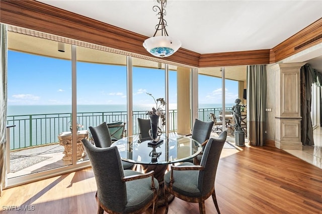 sunroom / solarium featuring a water view