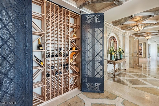 wine cellar with beamed ceiling, ornamental molding, and coffered ceiling