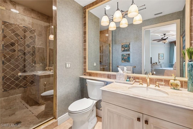 bathroom with vanity, ceiling fan, a shower with door, and toilet