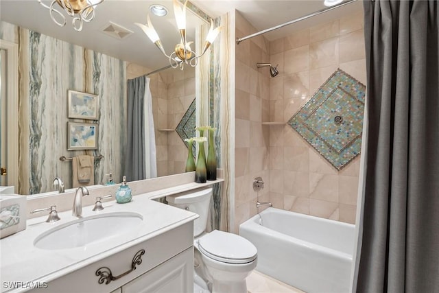 full bathroom featuring a notable chandelier, vanity, shower / bath combination with curtain, and toilet