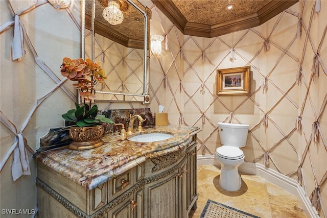 bathroom with vanity, crown molding, and toilet