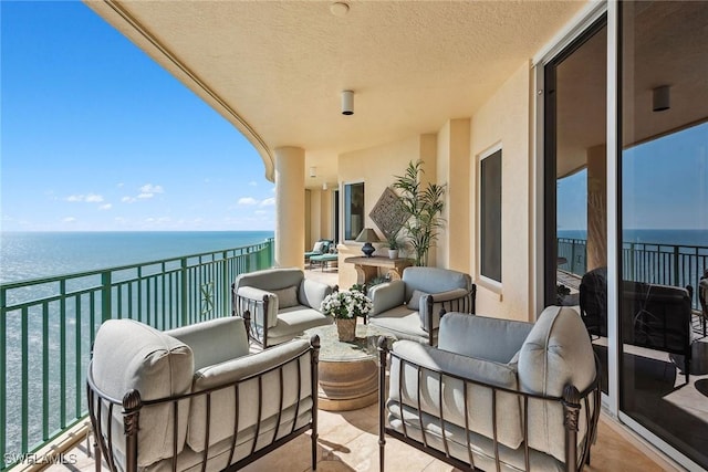 balcony featuring a water view and outdoor lounge area