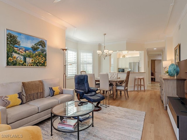 living area with ornamental molding, a chandelier, visible vents, and light wood-style flooring