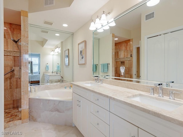 bathroom featuring a garden tub, visible vents, and a sink