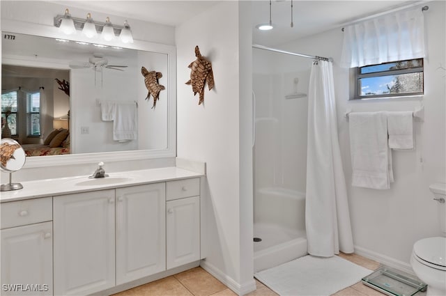 bathroom with toilet, a healthy amount of sunlight, ceiling fan, and walk in shower