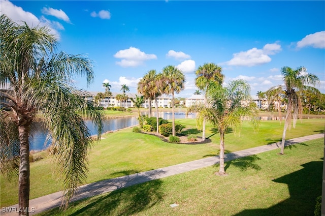 view of property's community with a yard and a water view