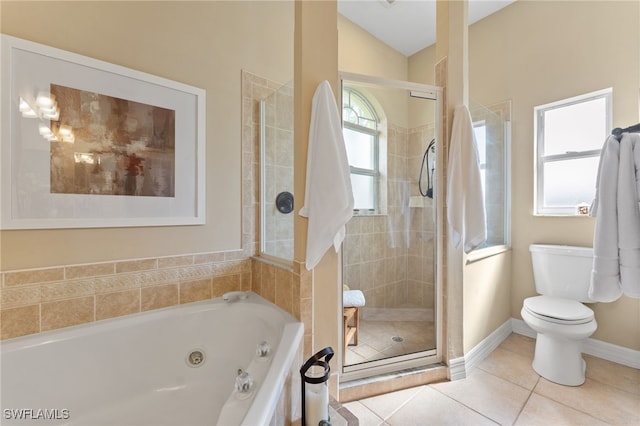 bathroom with tile patterned flooring, vaulted ceiling, toilet, and separate shower and tub