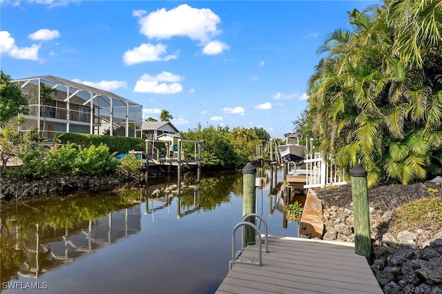 view of dock with a water view and glass enclosure