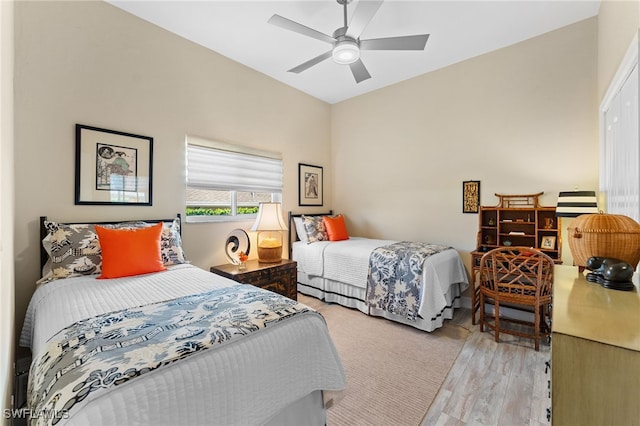 bedroom with light wood finished floors and a ceiling fan