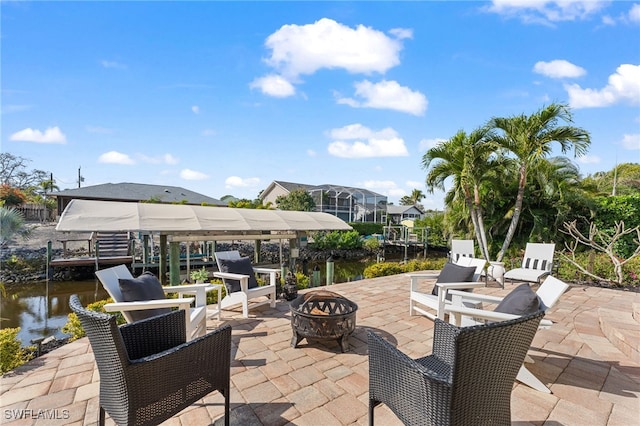 view of patio / terrace featuring a water view and a fire pit