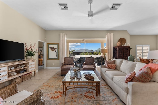 tiled living room featuring ceiling fan and a healthy amount of sunlight