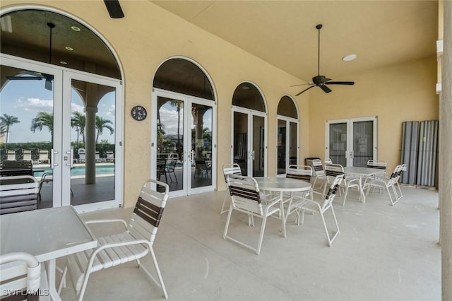 view of patio / terrace with french doors, ceiling fan, and a community pool