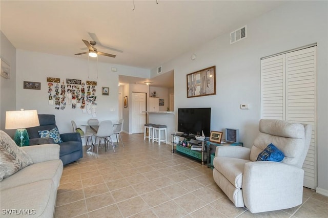 tiled living room with ceiling fan