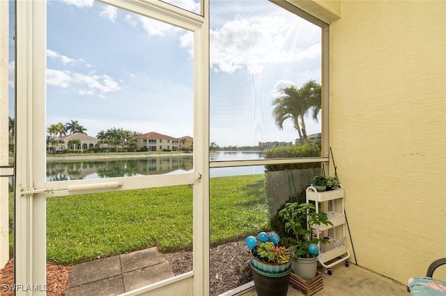 sunroom / solarium with a water view and plenty of natural light