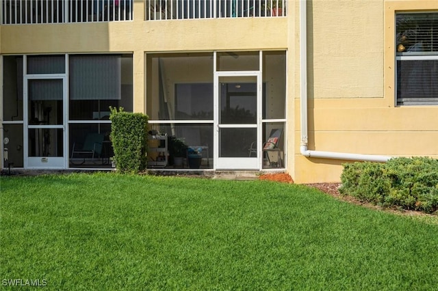 doorway to property featuring a yard