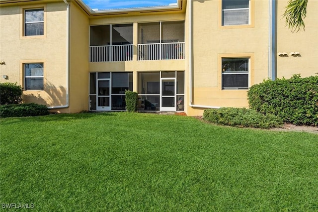 rear view of property with a yard