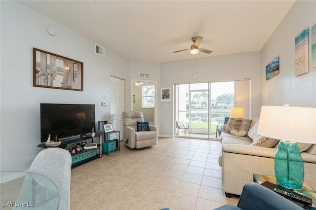 tiled living room featuring ceiling fan