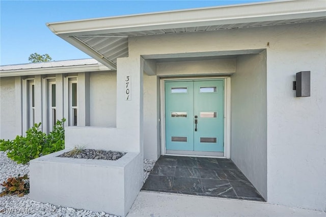 doorway to property with stucco siding