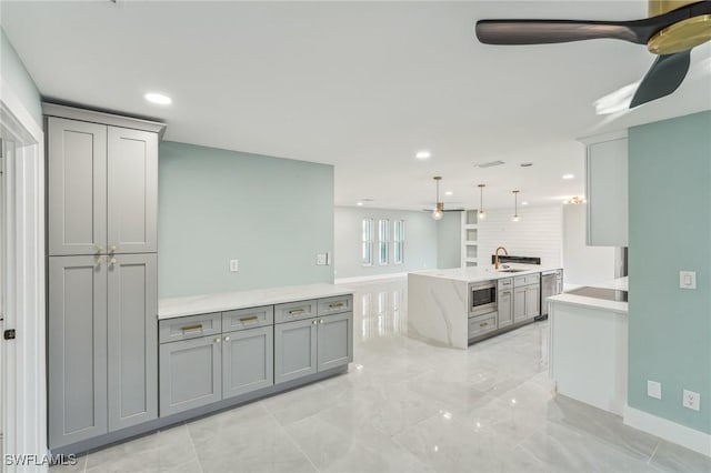 kitchen with stainless steel appliances, recessed lighting, gray cabinetry, a ceiling fan, and a sink