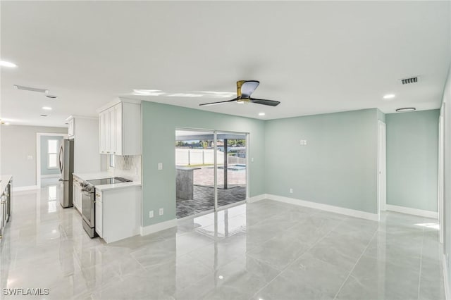 interior space with stainless steel appliances, light countertops, plenty of natural light, and visible vents