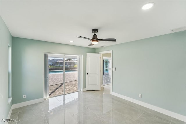 spare room with recessed lighting, a ceiling fan, and baseboards