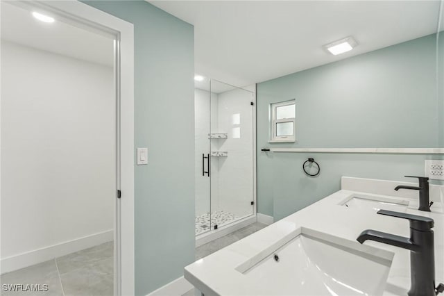 bathroom featuring baseboards, a sink, and a shower stall