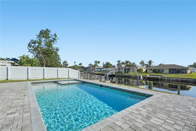 view of swimming pool featuring a patio area, fence, and a fenced in pool