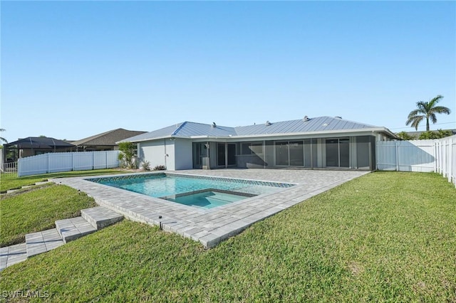 rear view of property with a fenced in pool, a yard, a sunroom, metal roof, and a fenced backyard