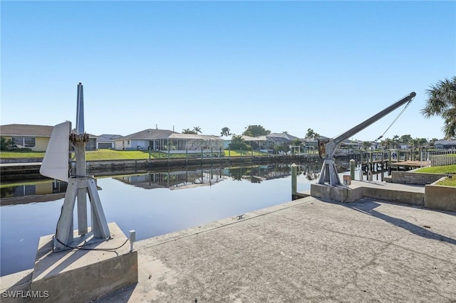 dock area with a water view and a residential view