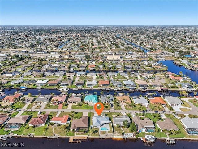 drone / aerial view with a residential view and a water view