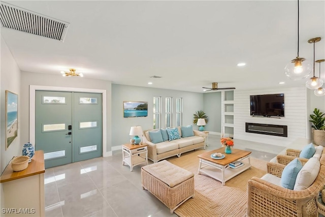 living room with a large fireplace, baseboards, visible vents, and french doors